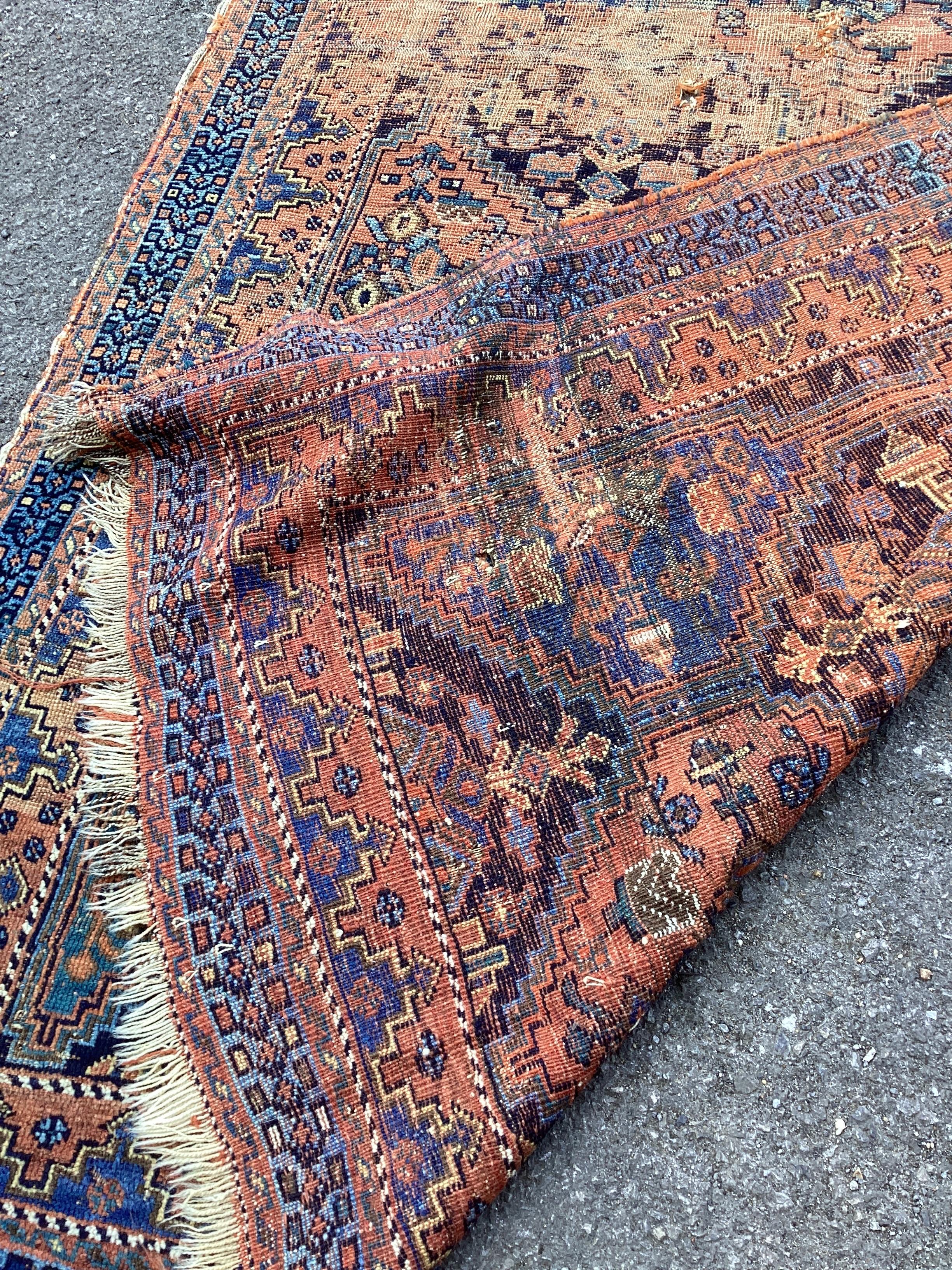 An antique Afshar blue ground rug 165cm x 133cm.